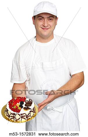 Stock Image - An italian pastry cook show off his creation, a cake decorated with chocolate chips, whipped creap and fresh fruits. Fotosearch