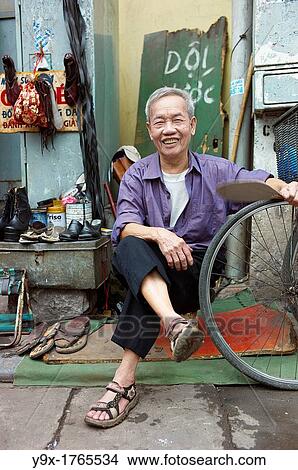An old man on the side of the street who fixes old shoes View Large Photo Image Picture - An old man on the side of the street who fixes old shoes. Fotosearch