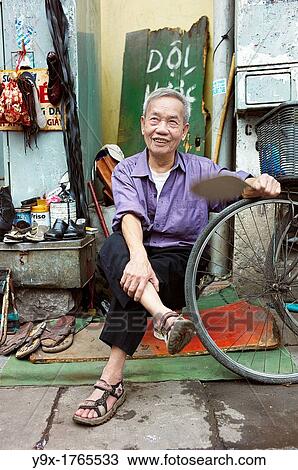 An old man on the side of the street who fixes old shoes View Large Photo Image Stock Image - An old man on the side of the street who fixes old shoes. Fotosearch