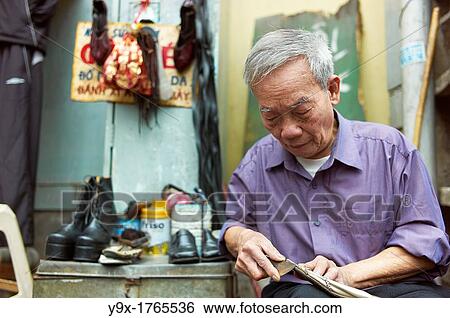 An old man on the side of the street who fixes old shoes View Large Photo Image Stock Photograph - An old man on the side of the street who fixes old shoes. Fotosearch