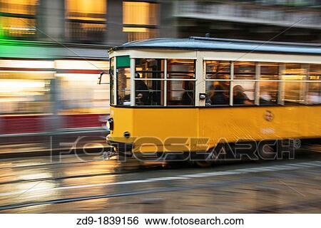 An old streetcar speeds along on a rainy night in Milan View Large Photo Image Stock Photograph - An old streetcar speeds along on a rainy night in Milan. Fotosearch