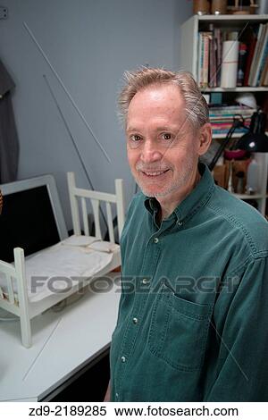 An older man enjoys his mancave. View Large Photo Image Stock Photography - An older man enjoys his mancave.. Fotosearch