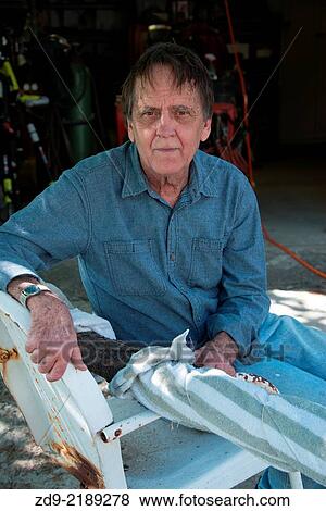An older man pauses at his workshop. View Large Photo Image Stock Photo - An older man pauses at his workshop.. Fotosearch