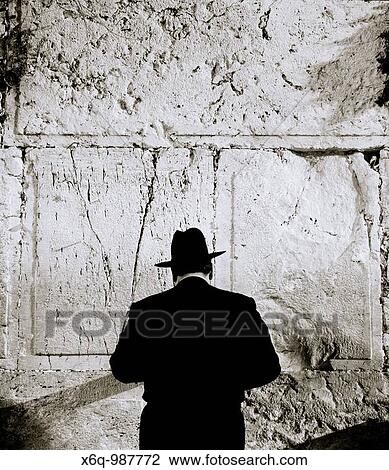 Stock Image - An Orthodox Jewish man conducts his prayers at the Wailing Wall, in Jerusalem, Israel. Fotosearch