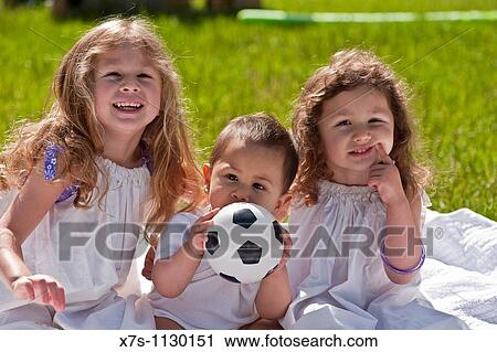 An outside portrait of two young girls with their baby boy brother View Large Photo Image Stock Image - An outside portrait of two young girls with their baby boy brother. Fotosearch