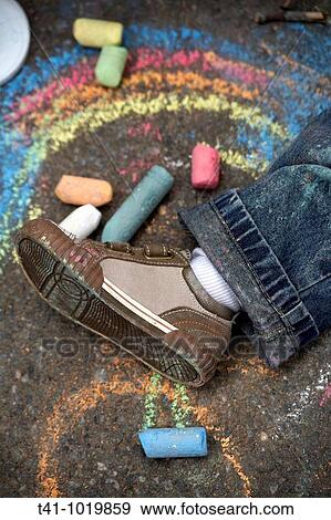 An overhead photograph of a 2 year old boy's shoe on a sidewalk surrounded by chalk and drawings View Large Photo Image Stock Photo - An overhead photograph of a 2 year old boy's shoe on a sidewalk surrounded by chalk and drawings. Fotosearch