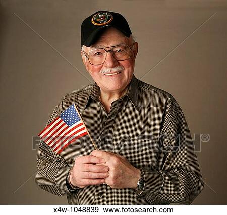 An proud American senior World War II veteran holding flag View Large Photo Image Stock Photo - An proud American senior World War II veteran holding flag. Fotosearch