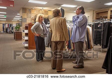 Stock Photograph - An unemployed Hispanic man proudly gets new business clothing from Working Wardrobes,. Fotosearch