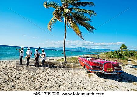Ancon beach, Classic car and music band, Trinidad city, Sancti Spiritus Province, Cuba. View Large Photo Image Stock Photograph - Ancon beach, Classic car and music band, Trinidad city, Sancti Spiritus Province, Cuba.. Fotosearch