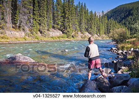 Angler fishing in the Maligne River, Alberta, Canada View Large Photo Image Stock Photo - Angler fishing in the Maligne River, Alberta, Canada. Fotosearch