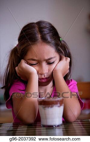 Angry girl in front of a glass with milk View Large Photo Image Stock Image - Angry girl in front of a glass with milk. Fotosearch