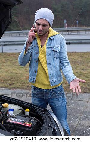 Stock Image - Angry Man With broken Down Car. Fotosearch