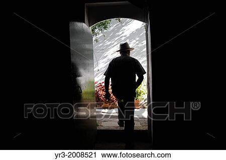 Stock Image - Antonio Mulero, owner of Los Tamayos organic farm, leaves a room in Prado del Rey, Cadiz, Andalusia, Spain. Fotosearch