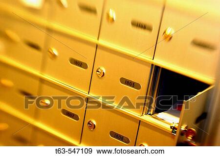 aparment mail boxes with one open and mail inside View Large Photo Image Stock Photo - aparment mail boxes with one open and mail inside. Fotosearch