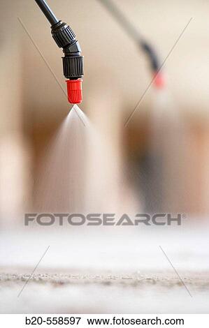 Stock Photo - Aplying anti-dust agent with spray, housing construction. Guipuzcoa, Euskadi, Spain. Fotosearch