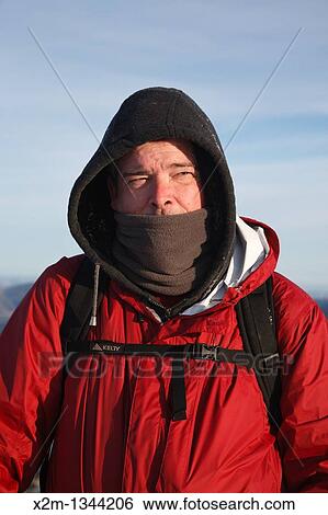Stock Photograph - Appalachian Trail - A winter hiker stands on the summit of Mount Moriah during the winter months in the White Mountains, New Hampshire USA. Fotosearch