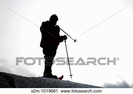 Stock Image - Appalachian Trail - The silhouette of a hiker on the summit of Mount Garfield during the winter months Located in the White Mountains, New Hampshire USA Model Release Yes Reference number 104. Fotosearch