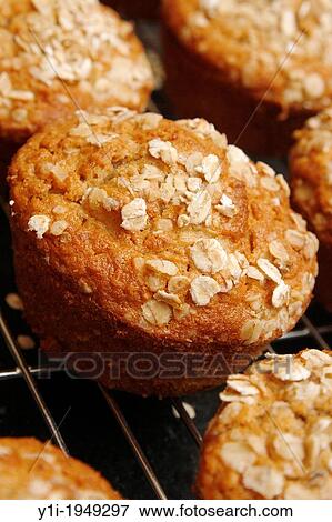 Stock Photo - apple and oat muffins cooling on wire rack.. Fotosearch