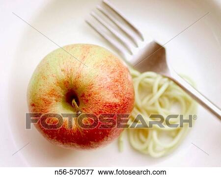 Apple, fork and pasta View Large Photo Image Stock Photo - Apple, fork and pasta. Fotosearch