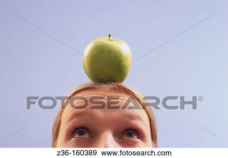 Stock Photo - Apple on woman's head. Fotosearch