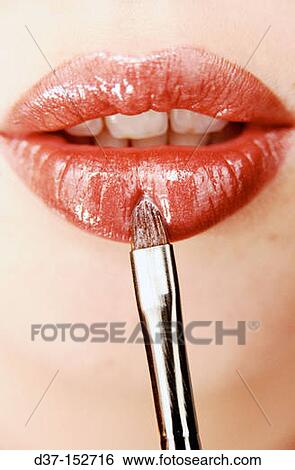 Applying lip-gloss View Large Photo Image Stock Photograph - Applying lip-gloss. Fotosearch