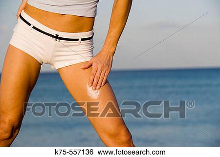 Applying sunscreen, protection, beach, caucasian-hispanic, age 20 to 40. View Large Photo Image Stock Photograph - Applying sunscreen, protection, beach, caucasian-hispanic, age 20 to 40.. Fotosearch