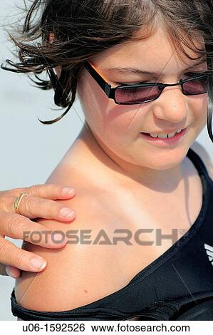 applying sunscreen to a 10 year old girl View Large Photo Image Stock Photograph - applying sunscreen to a 10 year old girl. Fotosearch