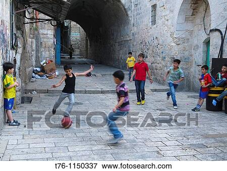 Arab boys playing soccer in the old city of Jerusalem View Large Photo Image Stock Photo - Arab boys playing soccer in the old city of Jerusalem. Fotosearch