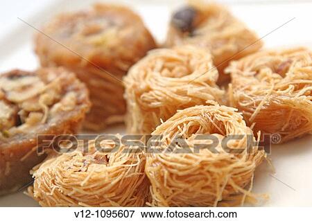 Arabic Sweets Pastries, Konafa with nuts View Large Photo Image Stock Photo - Arabic Sweets Pastries, Konafa with nuts. Fotosearch