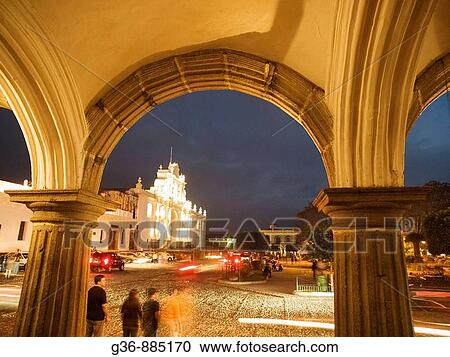 Stock Image - Arch with cathedral, seen through collonade off central square in Antigua, Sacatepequez, Guatemala. Fotosearch