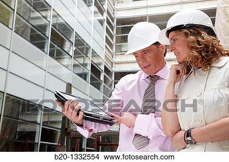 Architect and client with tablet PC in construction site View Large Photo Image Picture - Architect and client with tablet PC in construction site. Fotosearch