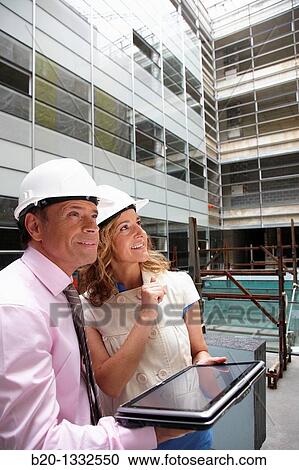 Architect and client with tablet PC in construction site View Large Photo Image Stock Image - Architect and client with tablet PC in construction site. Fotosearch