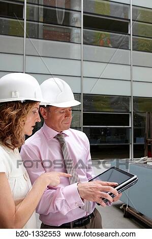 Architect and client with tablet PC in construction site View Large Photo Image Stock Image - Architect and client with tablet PC in construction site. Fotosearch