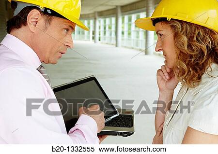 Architect and client with tablet PC in construction site View Large Photo Image Stock Photography - Architect and client with tablet PC in construction site. Fotosearch