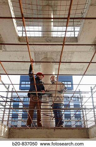 Architect and construction worker, personal protective equipment, housing construction, concrete skeleton View Large Photo Image Stock Image - Architect and construction worker, personal protective equipment, housing construction, concrete skeleton. Fotosearch