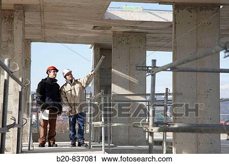 Architect and construction worker, personal protective equipment, housing construction, concrete skeleton View Large Photo Image Stock Image - Architect and construction worker, personal protective equipment, housing construction, concrete skeleton. Fotosearch