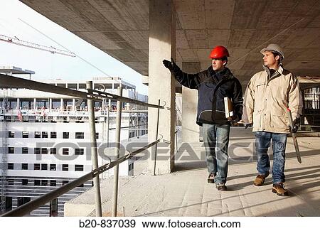 Architect and construction worker, personal protective equipment, housing construction, concrete skeleton View Large Photo Image Stock Photo - Architect and construction worker, personal protective equipment, housing construction, concrete skeleton. Fotosearch