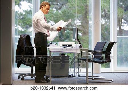 Architect with blueprints in office View Large Photo Image Stock Image - Architect with blueprints in office. Fotosearch