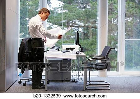 Architect with blueprints in office View Large Photo Image Stock Photo - Architect with blueprints in office. Fotosearch