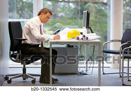 Architect with blueprints in office View Large Photo Image Stock Photography - Architect with blueprints in office. Fotosearch