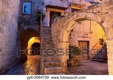 Stock Photo - archway and house in old town of Trogir at night, Croatia.. Fotosearch