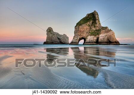 Stock Image - Archway Islands, sunrise, Wharariki beach, near Collingwood, Golden Bay, New Zealand. Fotosearch