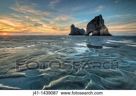Archway Islands, sunset, Wharariki beach, near Collingwood, Golden Bay, New Zealand View Large Photo Image Stock Photo - Archway Islands, sunset, Wharariki beach, near Collingwood, Golden Bay, New Zealand. Fotosearch