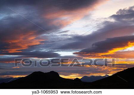 Stock Image - Argentina, The Lake District, Parque Nacional Nahuel Huapi A colourful sunset over the patagonian peaks to be found near Bariloche. Fotosearch