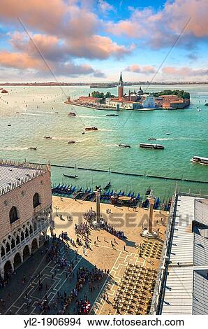 Picture - Arial view form St Mark's Campinale of St Mark's Square and the Doges with the island of San Giorgio Maggiore behind, with its church front designed by Andrea Palladio and begun in 1566 Venice Italy. Fotosearch