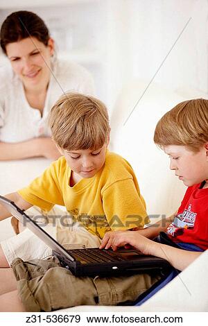 Ariane, Joshua, Yanik, Sitting, Sofa, Portable computer View Large Photo Image Stock Photo - Ariane, Joshua, Yanik, Sitting, Sofa, Portable computer. Fotosearch