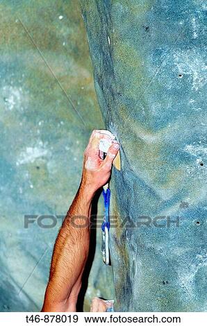 Stock Photo - Arm of a climber on climbing wall. Fotosearch
