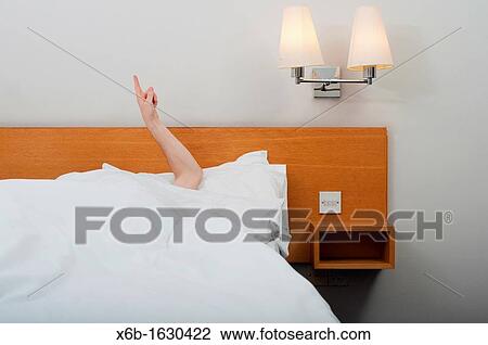 Arm pointing up from under bed covers View Large Photo Image Stock Image - Arm pointing up from under bed covers. Fotosearch