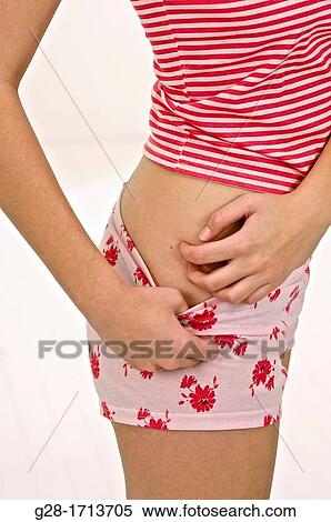 arms of young woman scratching her itching hip in red underwear, suffering from psoriasis or a rash View Large Photo Image Stock Photography - arms of young woman scratching her itching hip in red underwear, suffering from psoriasis or a rash. Fotosearch