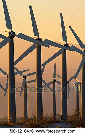 Array of Clean Energy Power generating windmills at wind farm at sunrise, Palm Springs, Riverside County, California View Large Photo Image Stock Photograph - Array of Clean Energy Power generating windmills at wind farm at sunrise, Palm Springs, Riverside County, California. Fotosearch